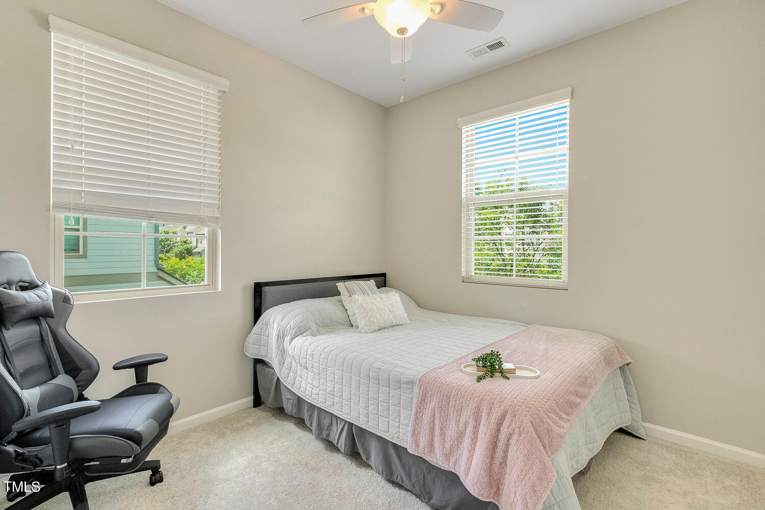 2425 Baslow Drive Apex, NC 27539 - Photo 37 of 48 a bedroom with a bed and a chair