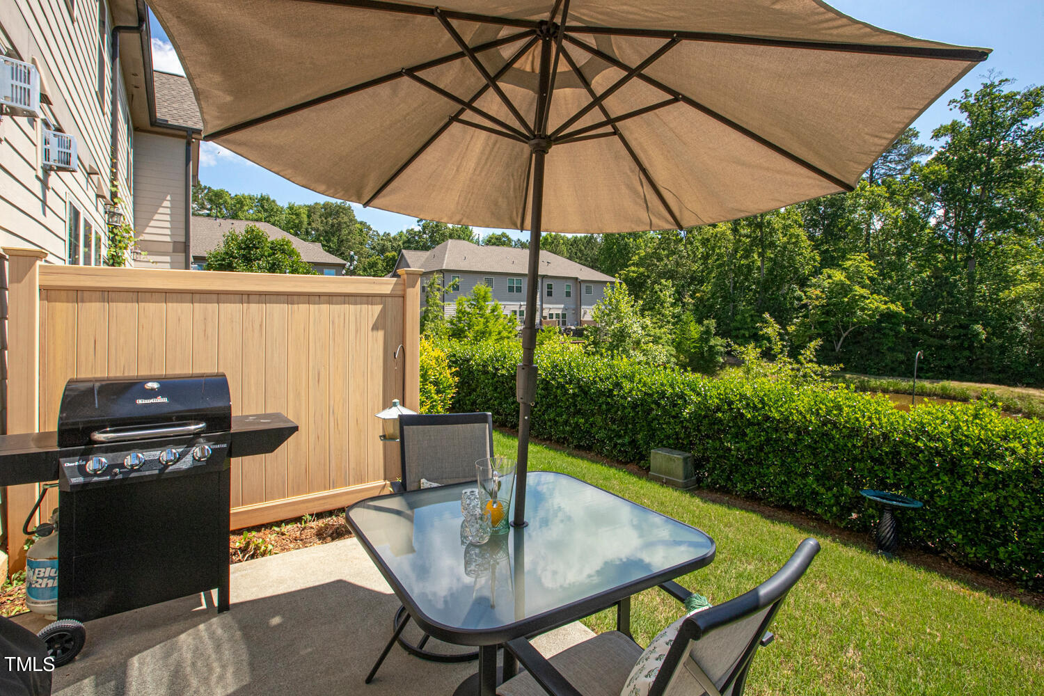 2425 Baslow Drive Apex, NC 27539 - Photo 39 of 48 a view of a patio with a table and chairs under an umbrella