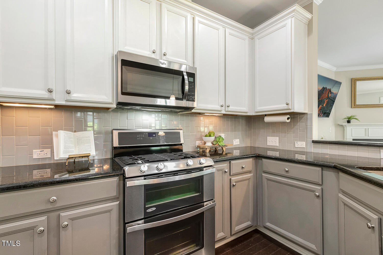 2425 Baslow Drive Apex, NC 27539 - Photo 9 of 48 a kitchen with granite countertop white cabinets and stainless steel appliances