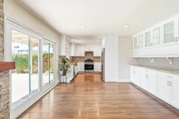 a kitchen with granite countertop a sink and a window