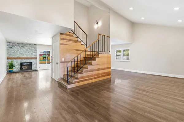 a view of entryway livingroom and hall with wooden floor