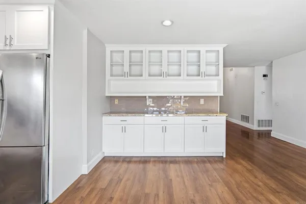 a kitchen with stainless steel appliances granite countertop a stove top oven a sink and a refrigerator