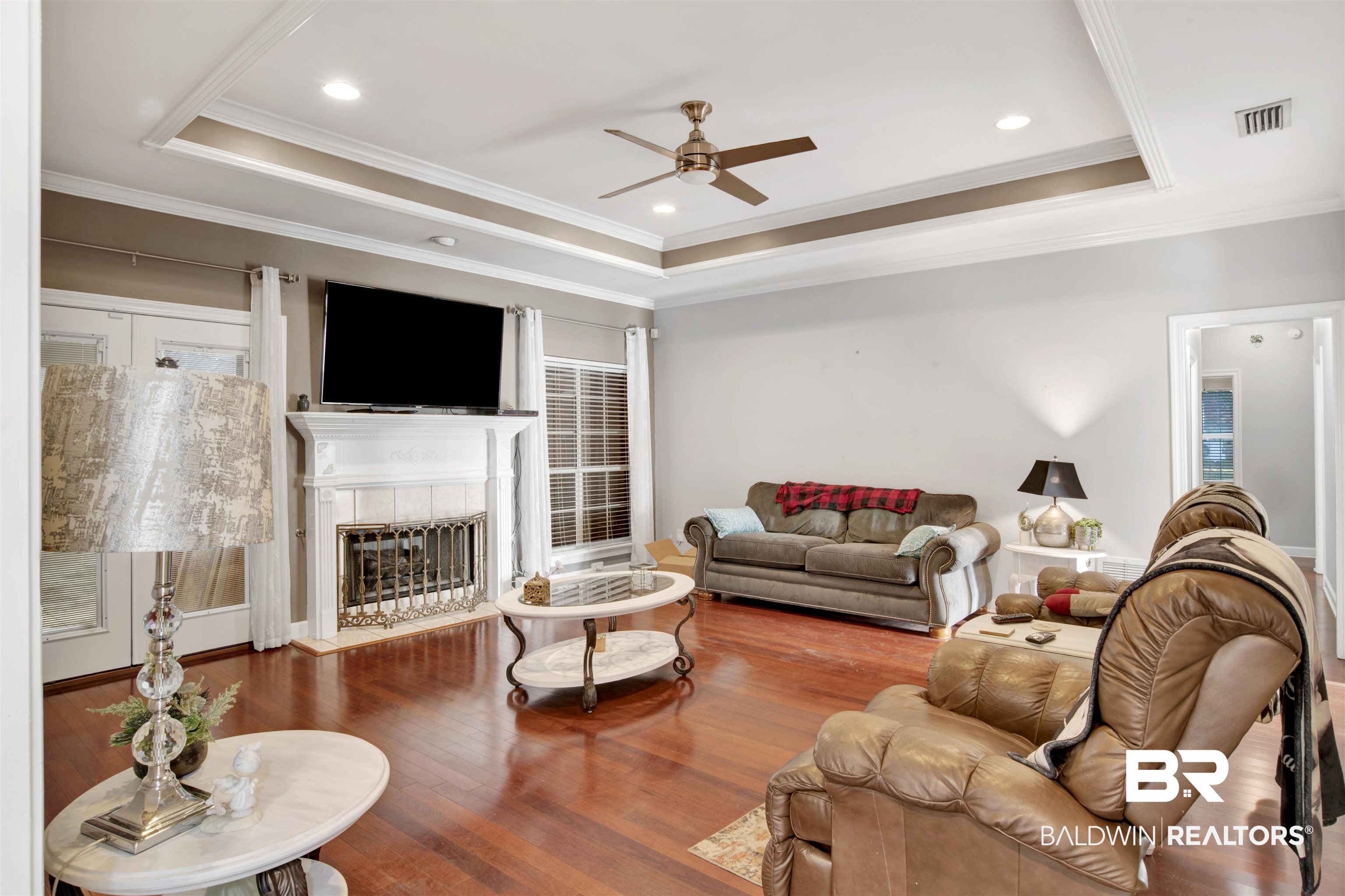 445 Wedgefield Drive South Mobile, AL 36608 - Photo 4 of 36 Living room featuring hardwood / wood-style flooring, a raised ceiling, ceiling fan, and crown molding