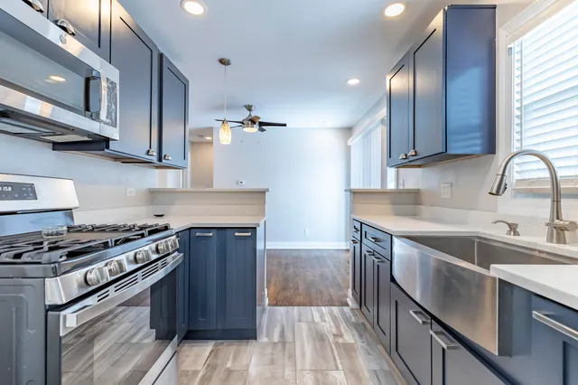 a kitchen with wooden cabinets stainless steel appliances and a sink