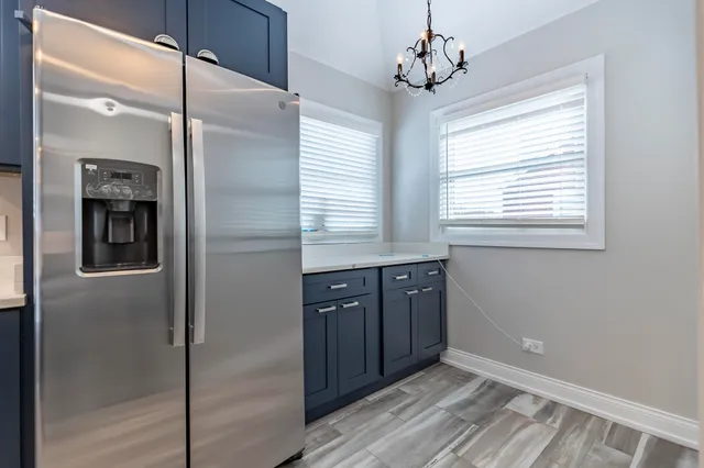 a kitchen with stainless steel appliances granite countertop a refrigerator and a sink