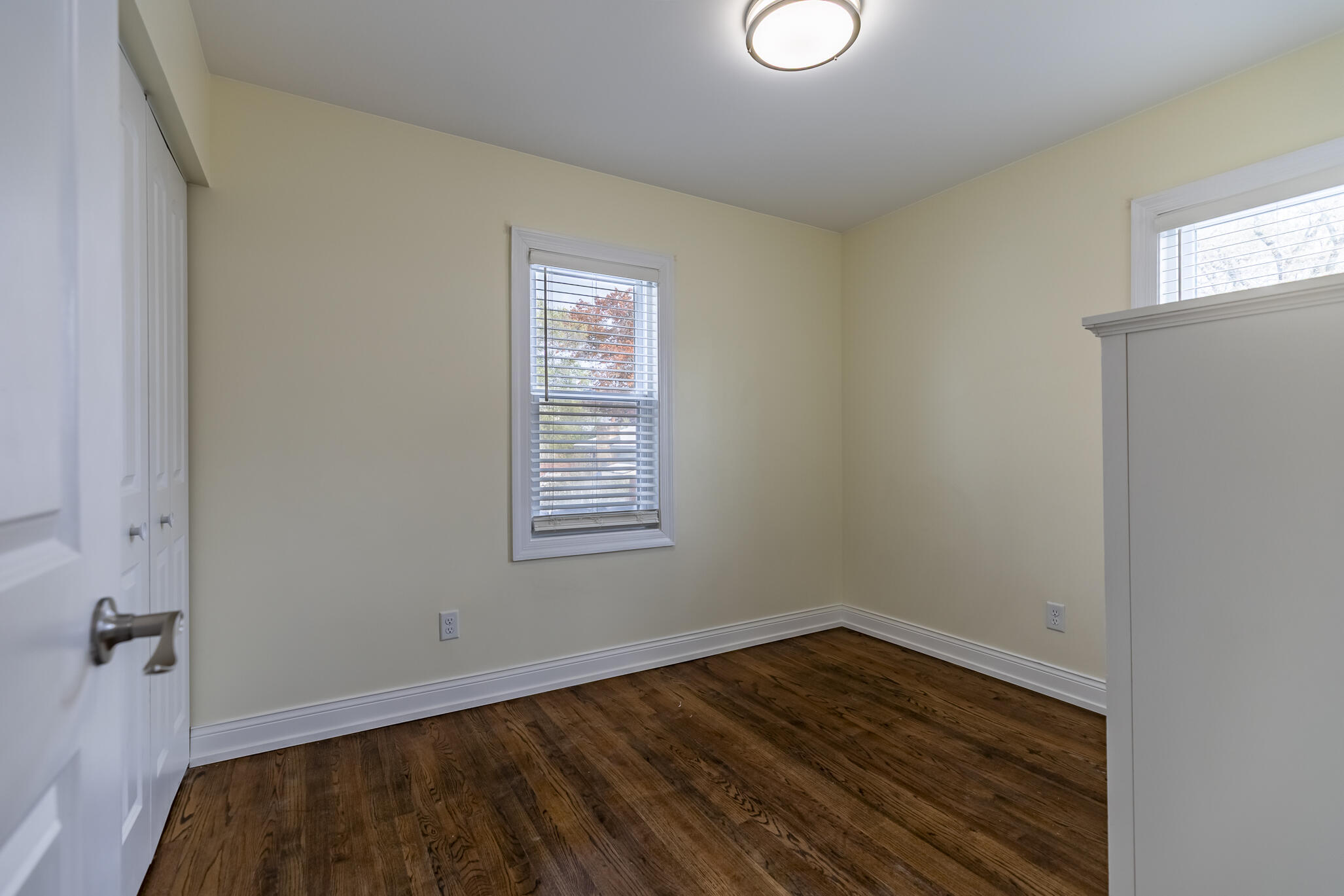 1035 Willard Street Gary, IN 46404 - Photo 21 of 30 a view of an empty room with wooden floor and a window