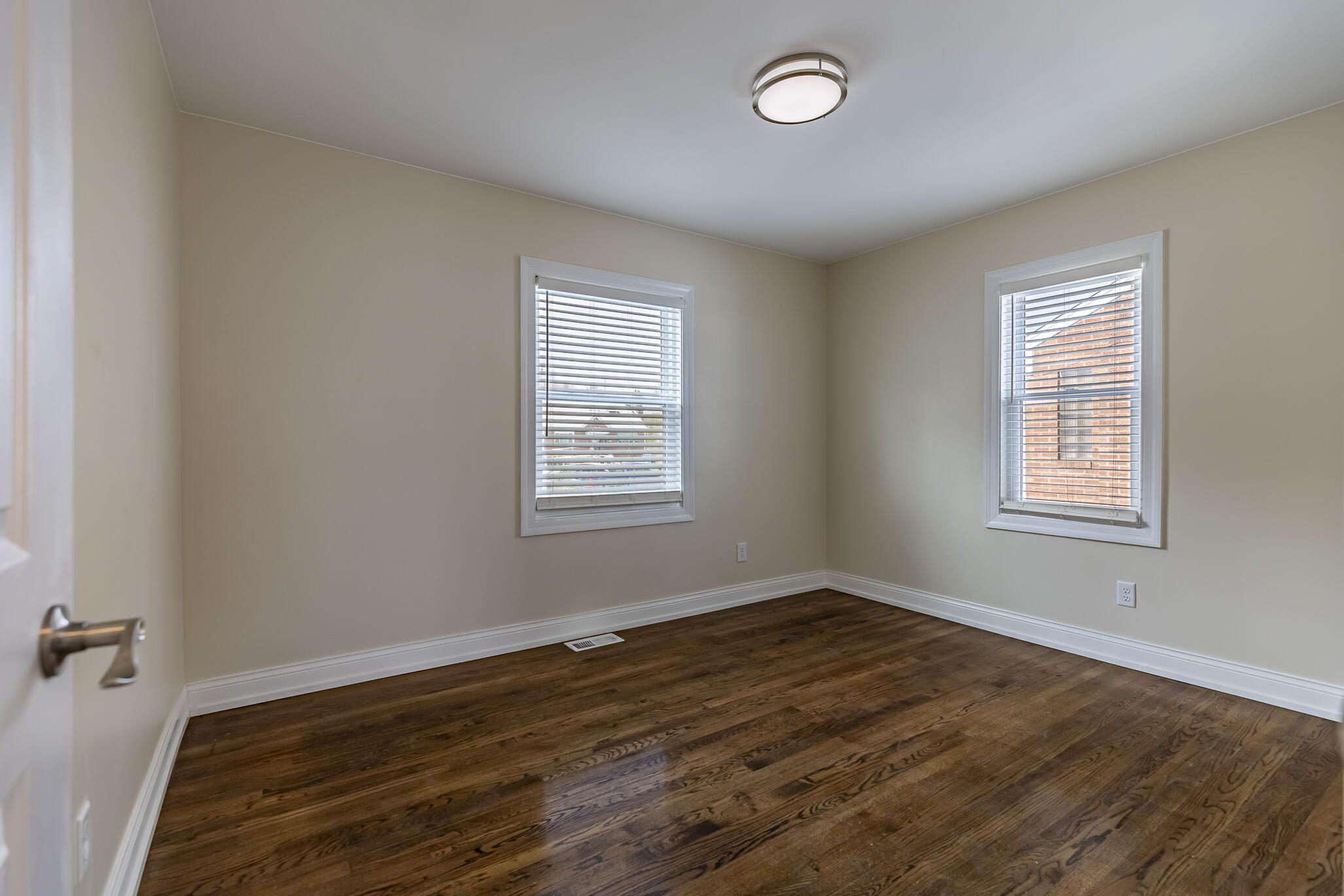 1035 Willard Street Gary, IN 46404 - Photo 22 of 30 an empty room with wooden floor and windows