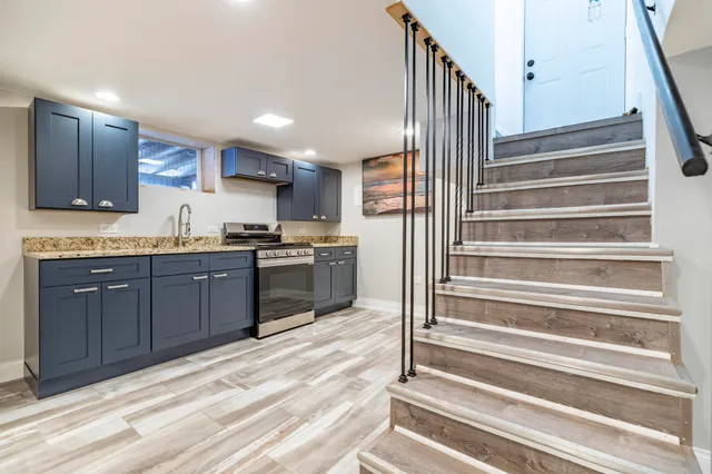 a kitchen with granite countertop wooden cabinets and white appliances