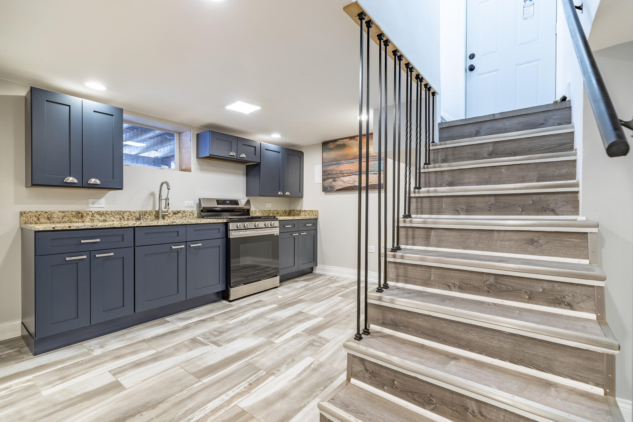 1035 Willard Street Gary, IN 46404 - Photo 27 of 30 a kitchen with granite countertop wooden cabinets and white appliances