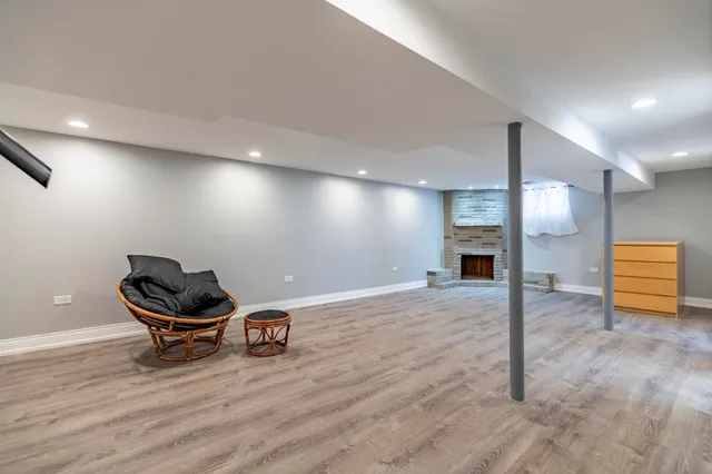 a room with a wooden floor and chairs