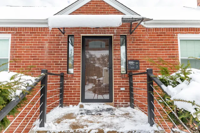 a view of a door and brick wall