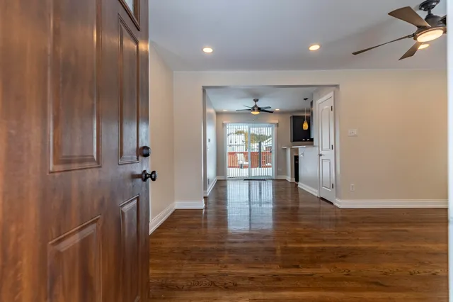 a view of empty room with wooden floor