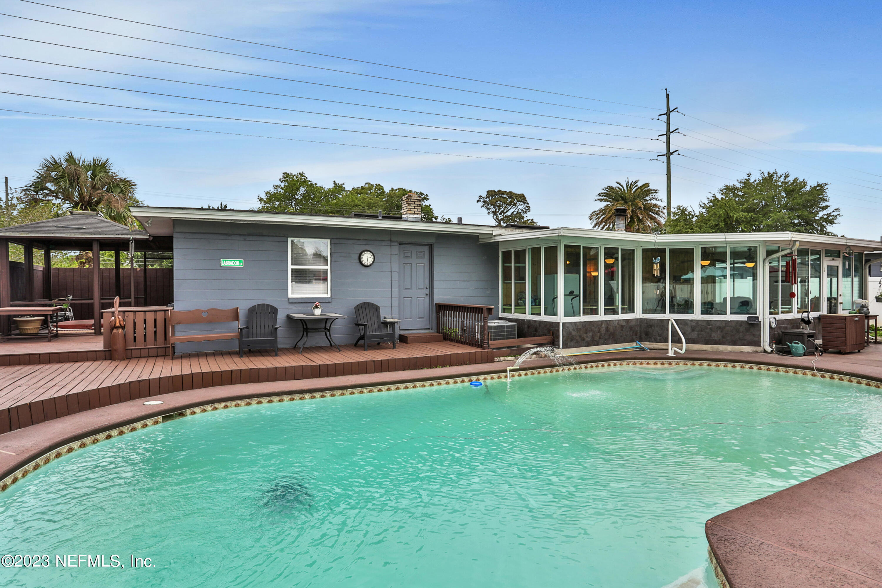 6853 Merrill Road Jacksonville, FL 32277 - Photo 1 of 36 a view of a house with swimming pool and porch