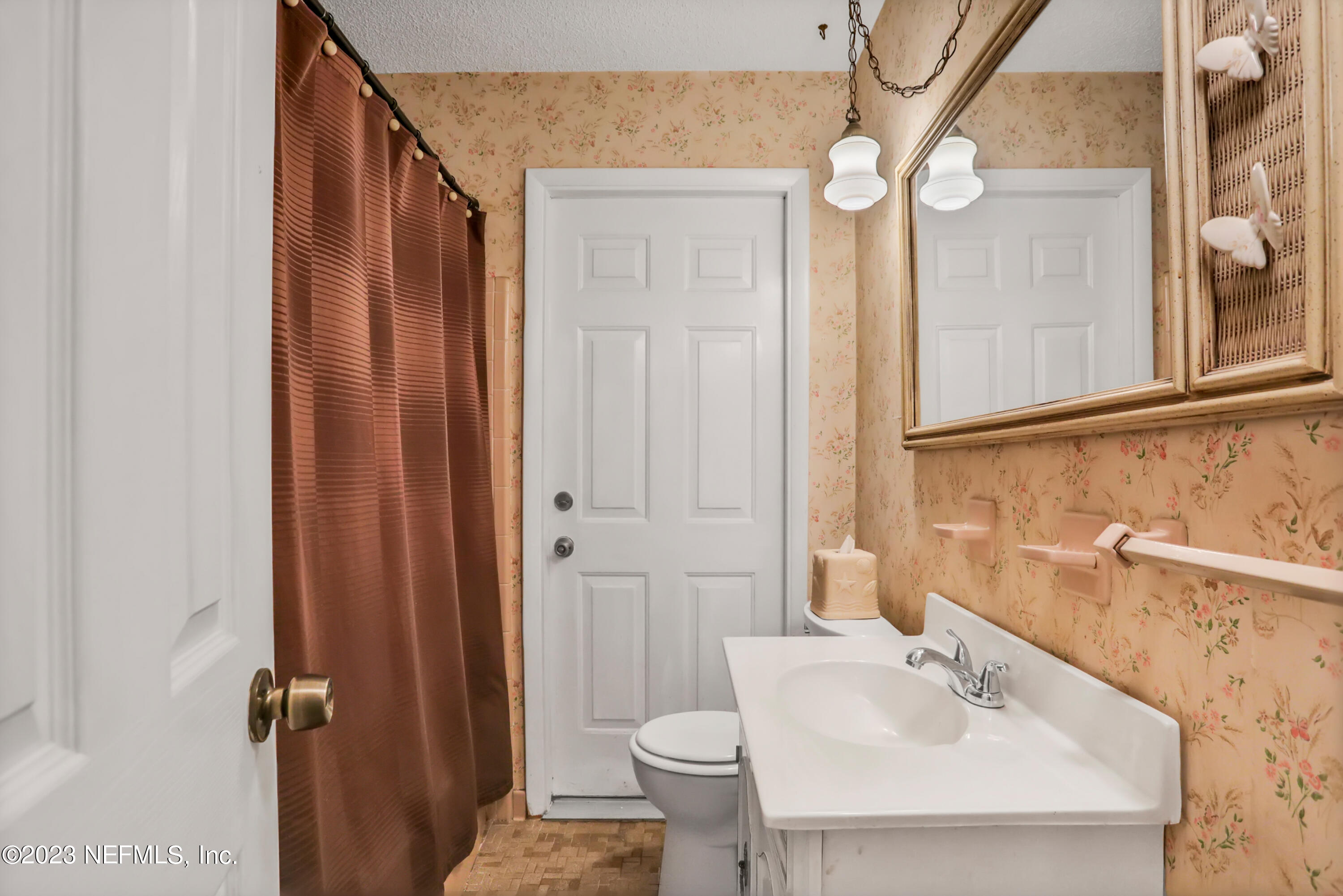 6853 Merrill Road Jacksonville, FL 32277 - Photo 11 of 36 a bathroom with a sink a toilet and shower