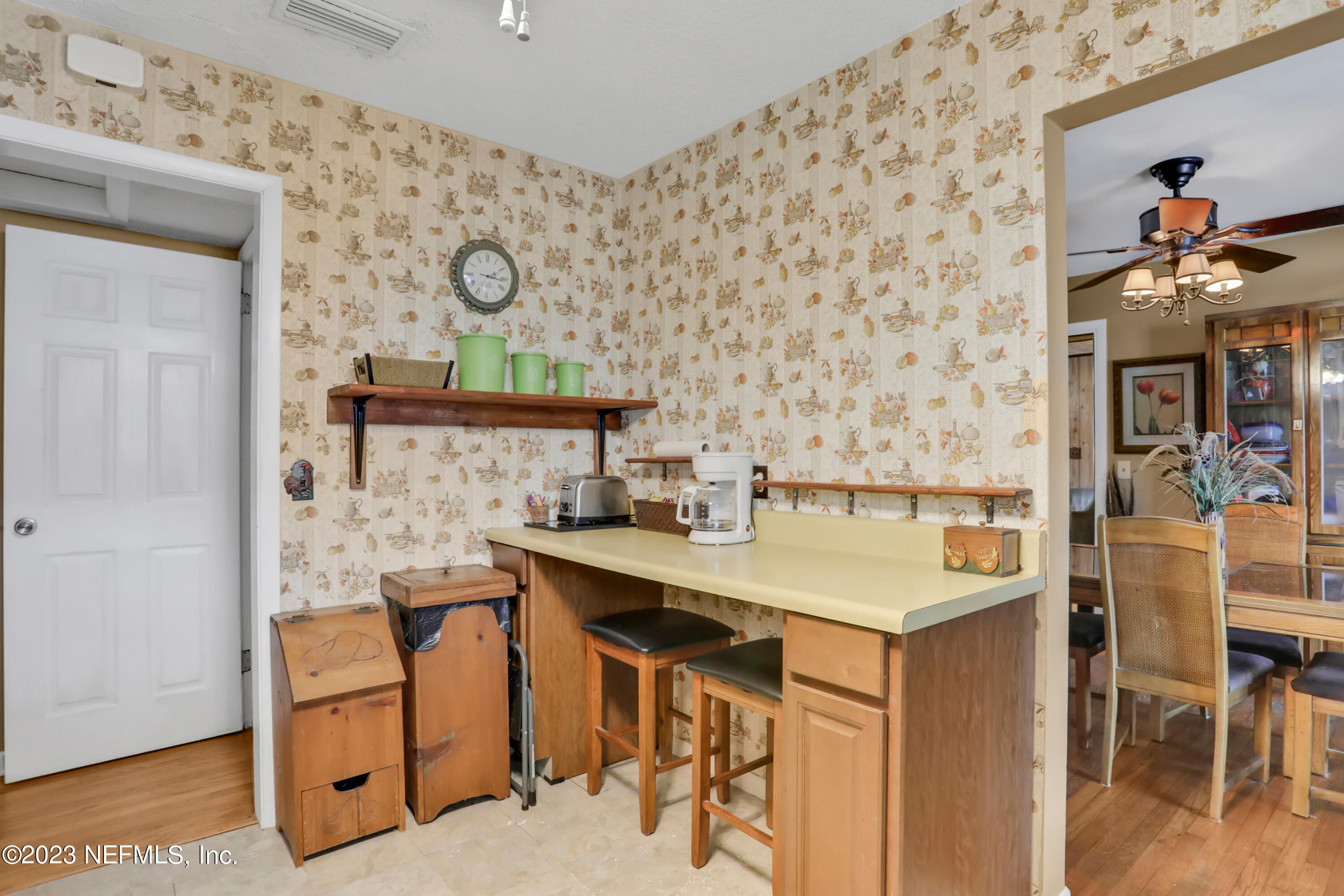 6853 Merrill Road Jacksonville, FL 32277 - Photo 21 of 36 a view of a dining room with furniture and wooden floor