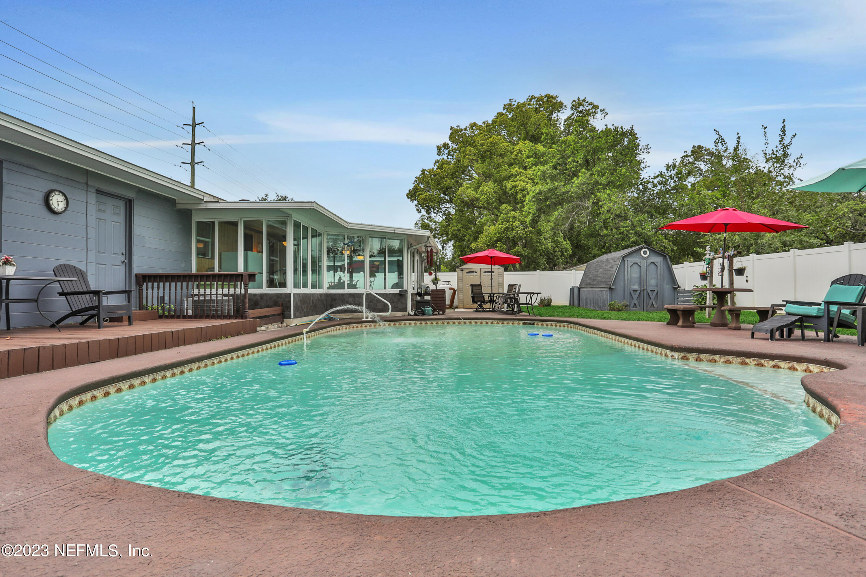 6853 Merrill Road Jacksonville, FL 32277 - Photo 34 of 36 a view of a swimming pool with a patio