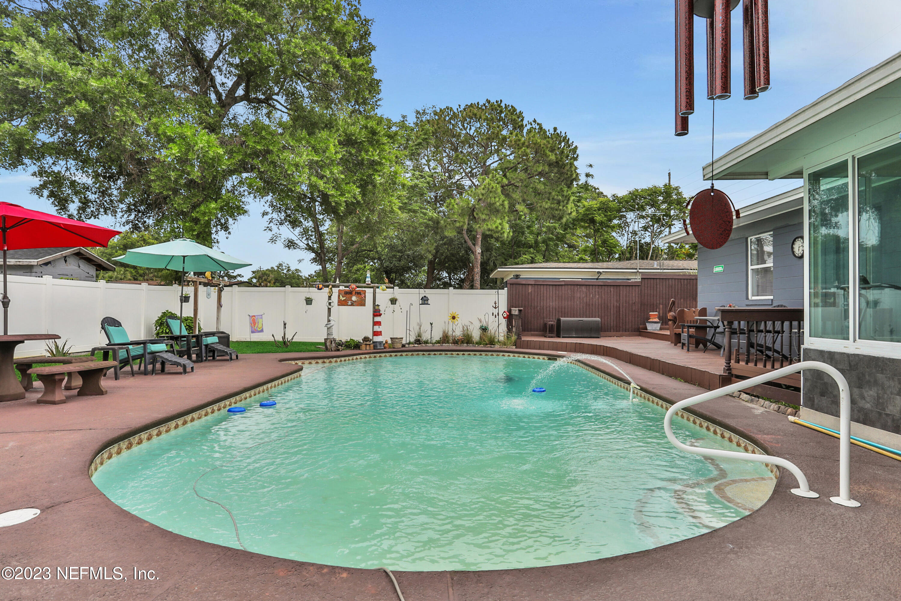 6853 Merrill Road Jacksonville, FL 32277 - Photo 35 of 36 an outdoor space with swimming pool and furniture
