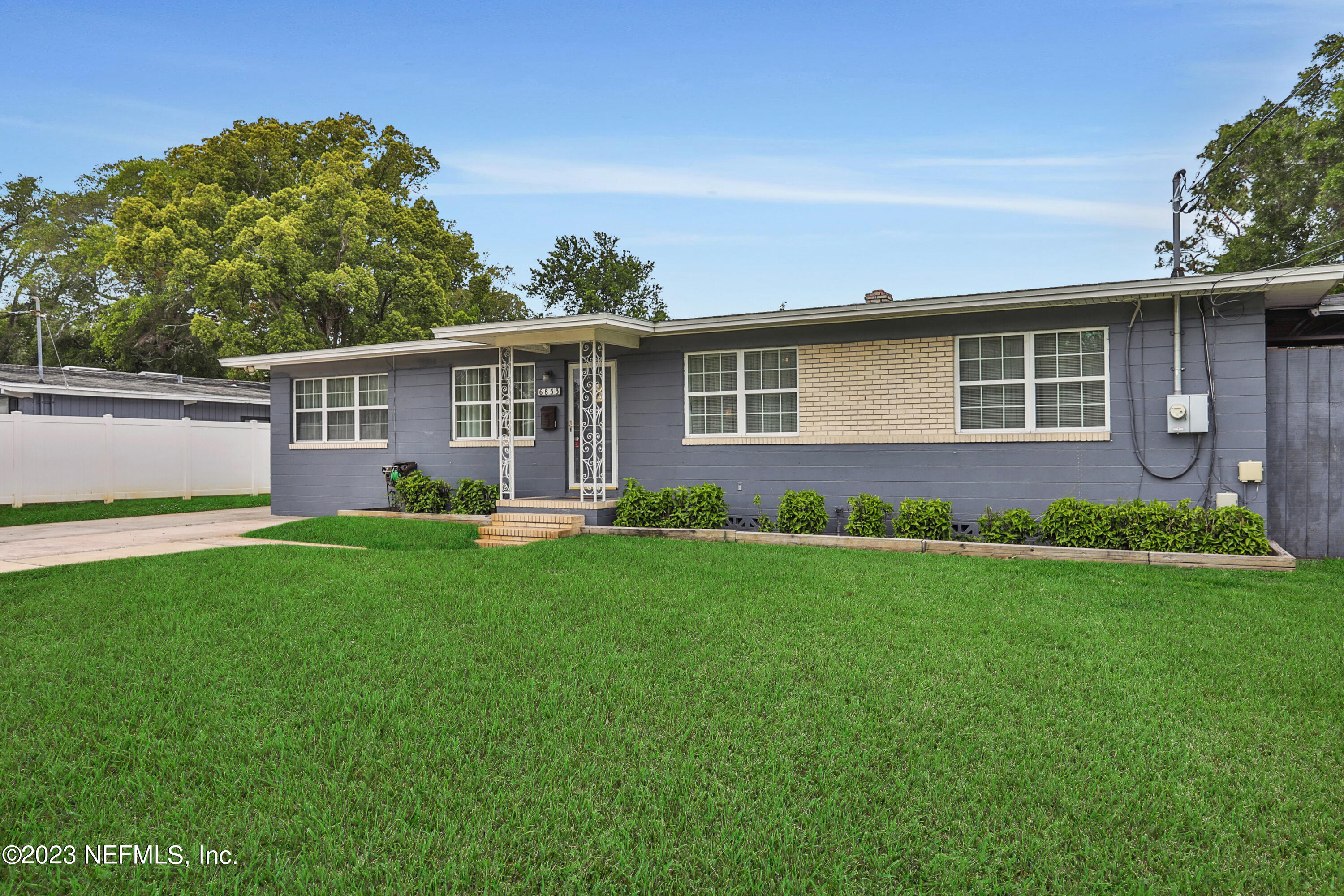 6853 Merrill Road Jacksonville, FL 32277 - Photo 4 of 36 a front view of house with yard and green space