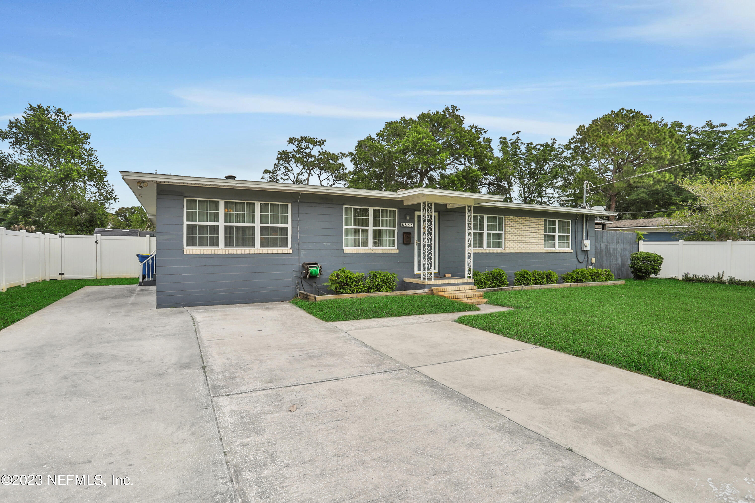 6853 Merrill Road Jacksonville, FL 32277 - Photo 5 of 36 front view of a house with a yard