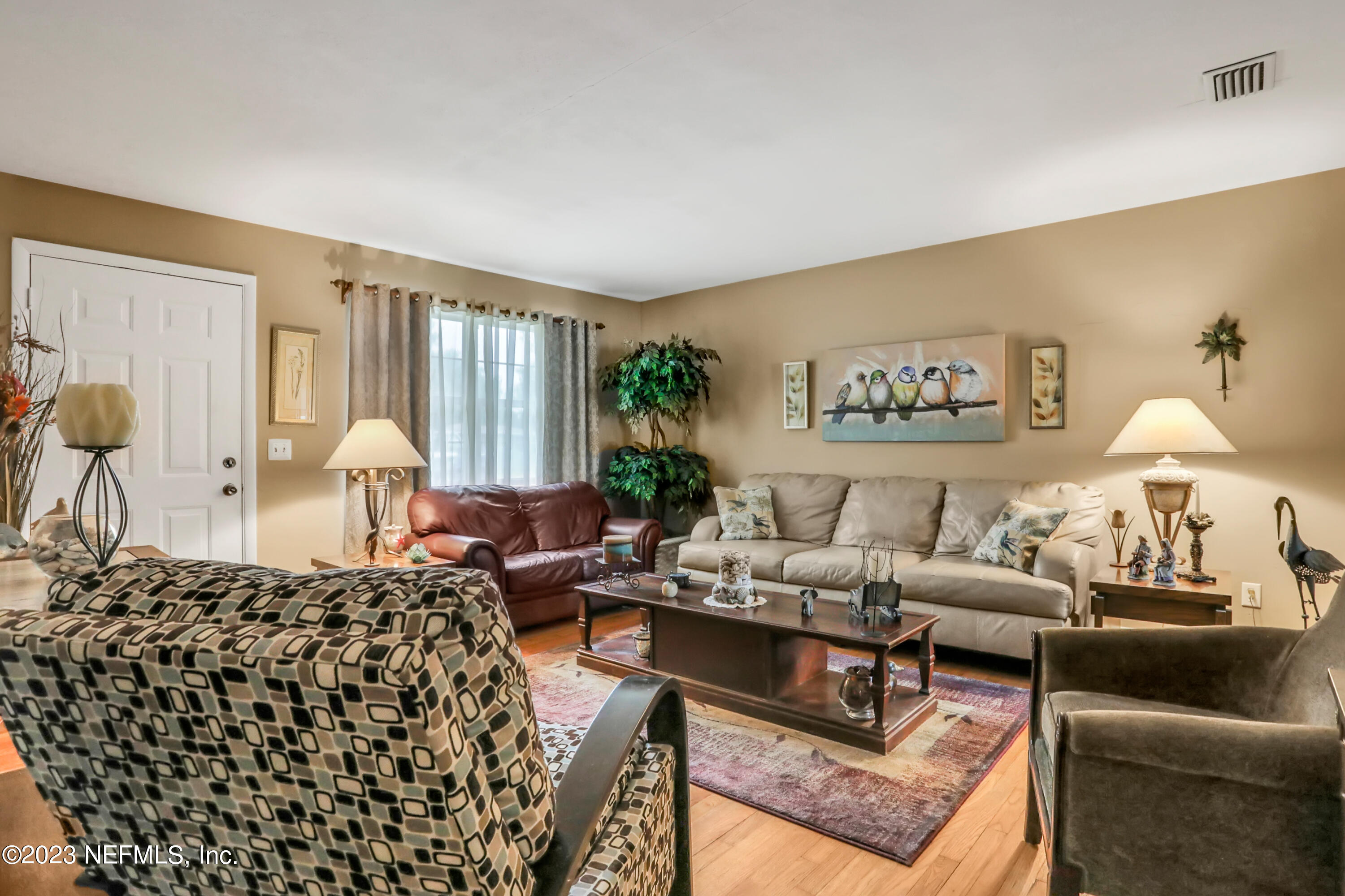 6853 Merrill Road Jacksonville, FL 32277 - Photo 8 of 36 a living room with furniture and a large window
