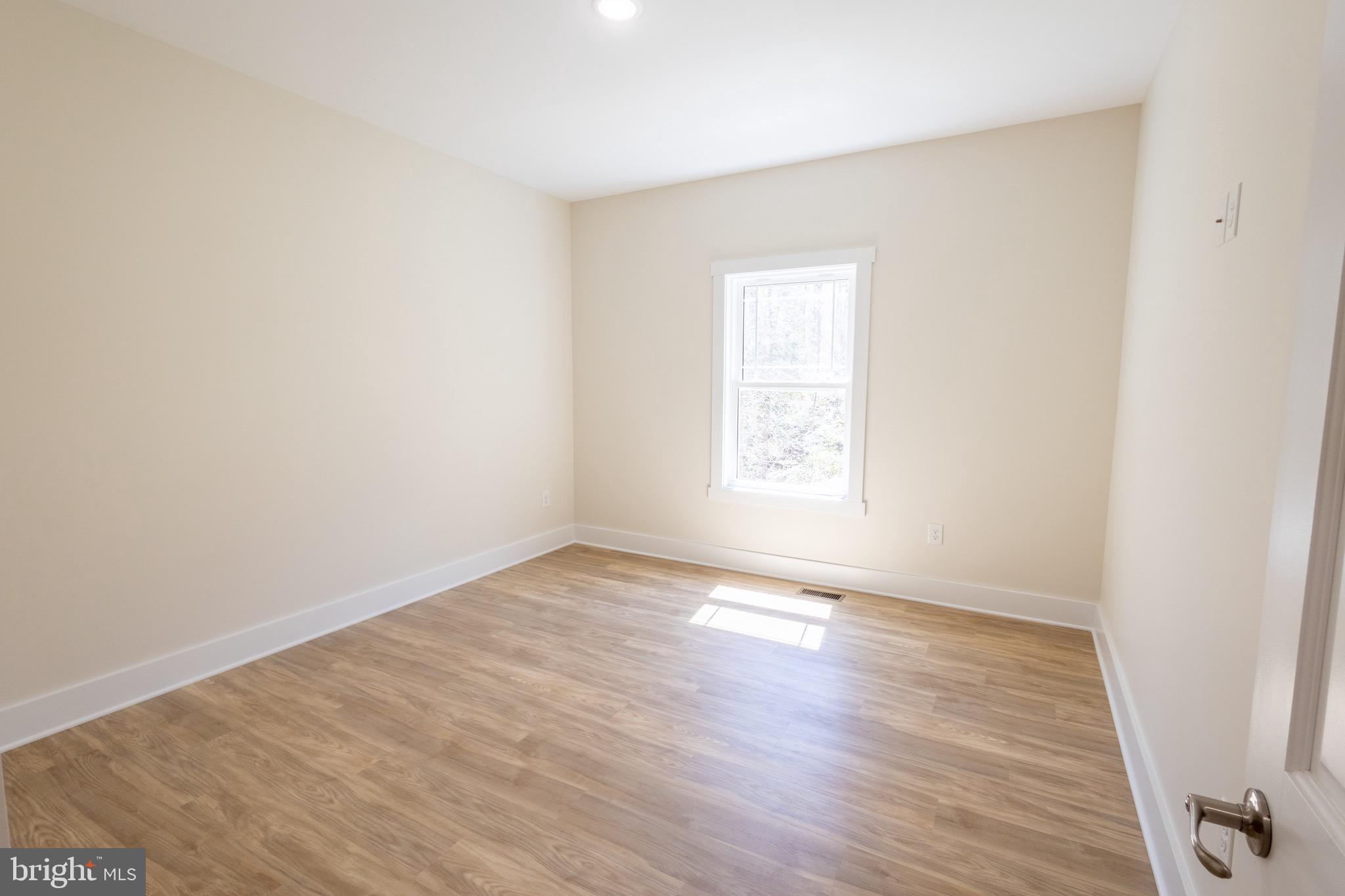 4 Windsor Drive King George, VA 22485 - Photo 16 of 48 an empty room with wooden floor and windows