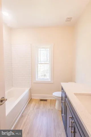 a bathroom with a sink a toilet and tub