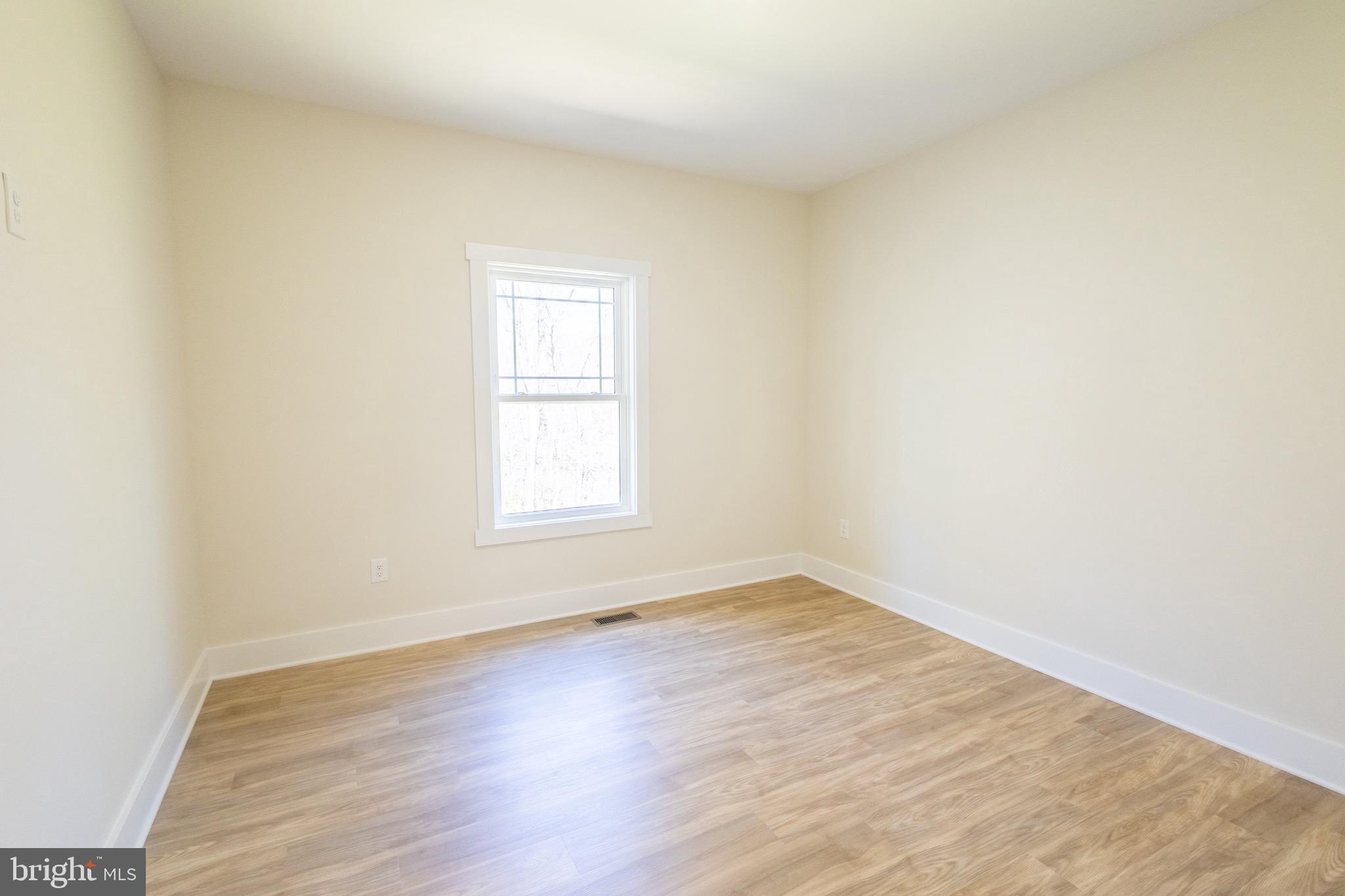 4 Windsor Drive King George, VA 22485 - Photo 19 of 48 an empty room with wooden floor and windows
