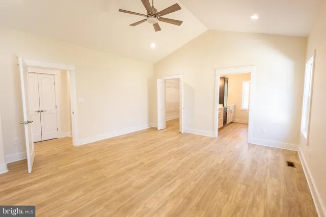 a view of a livingroom with wooden floor and a ceiling fan
