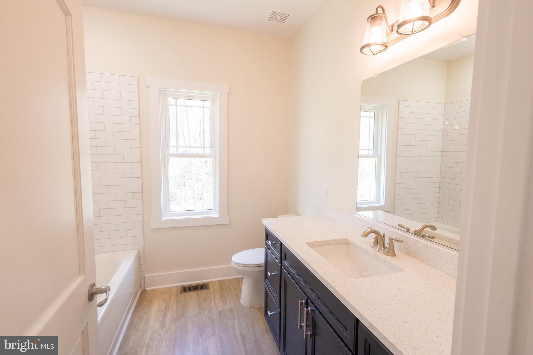 4 Windsor Drive King George, VA 22485 - Photo 25 of 48 a bathroom with a sink a toilet and a window