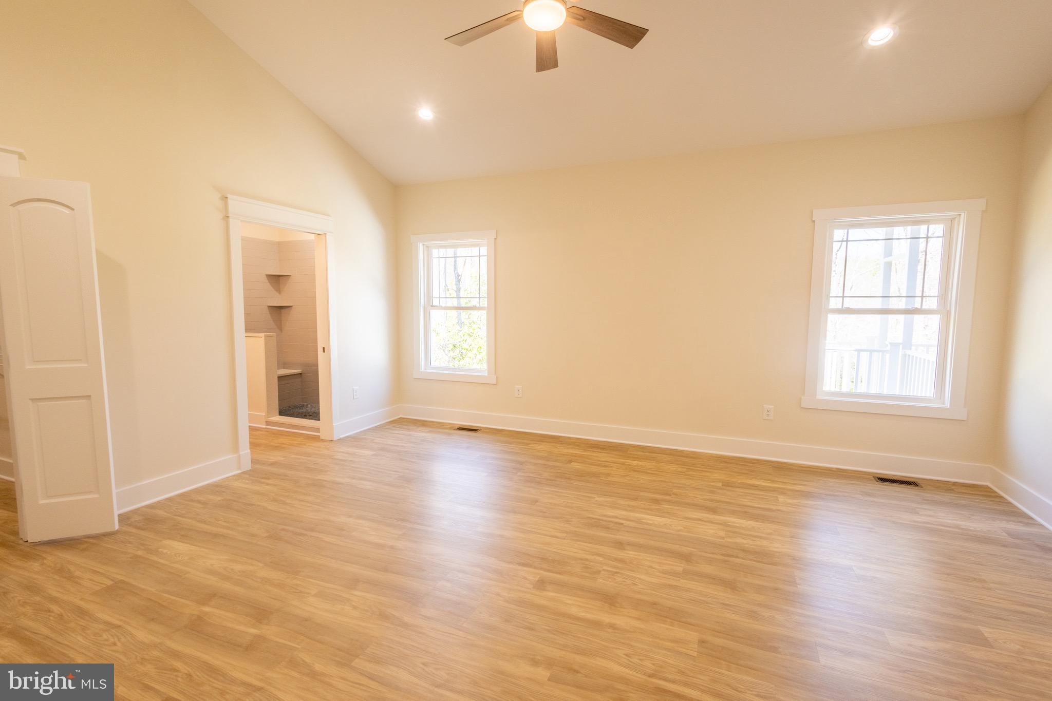 4 Windsor Drive King George, VA 22485 - Photo 26 of 48 an empty room with wooden floor chandelier fan and windows
