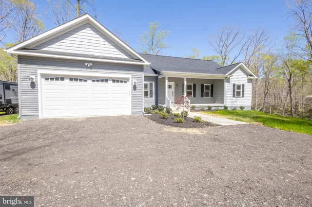 a view of a house with a yard and garage