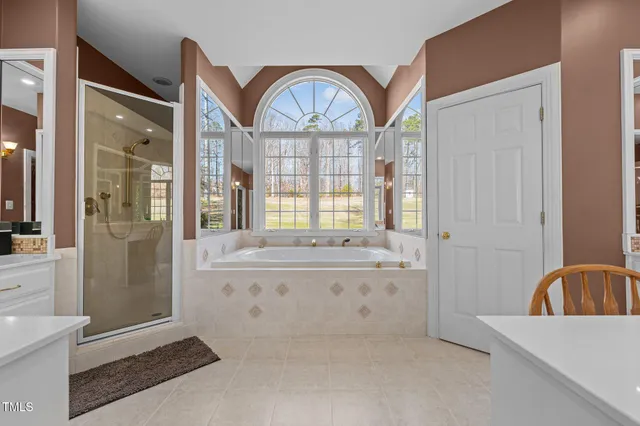 a view of a livingroom with furniture window and a kitchen