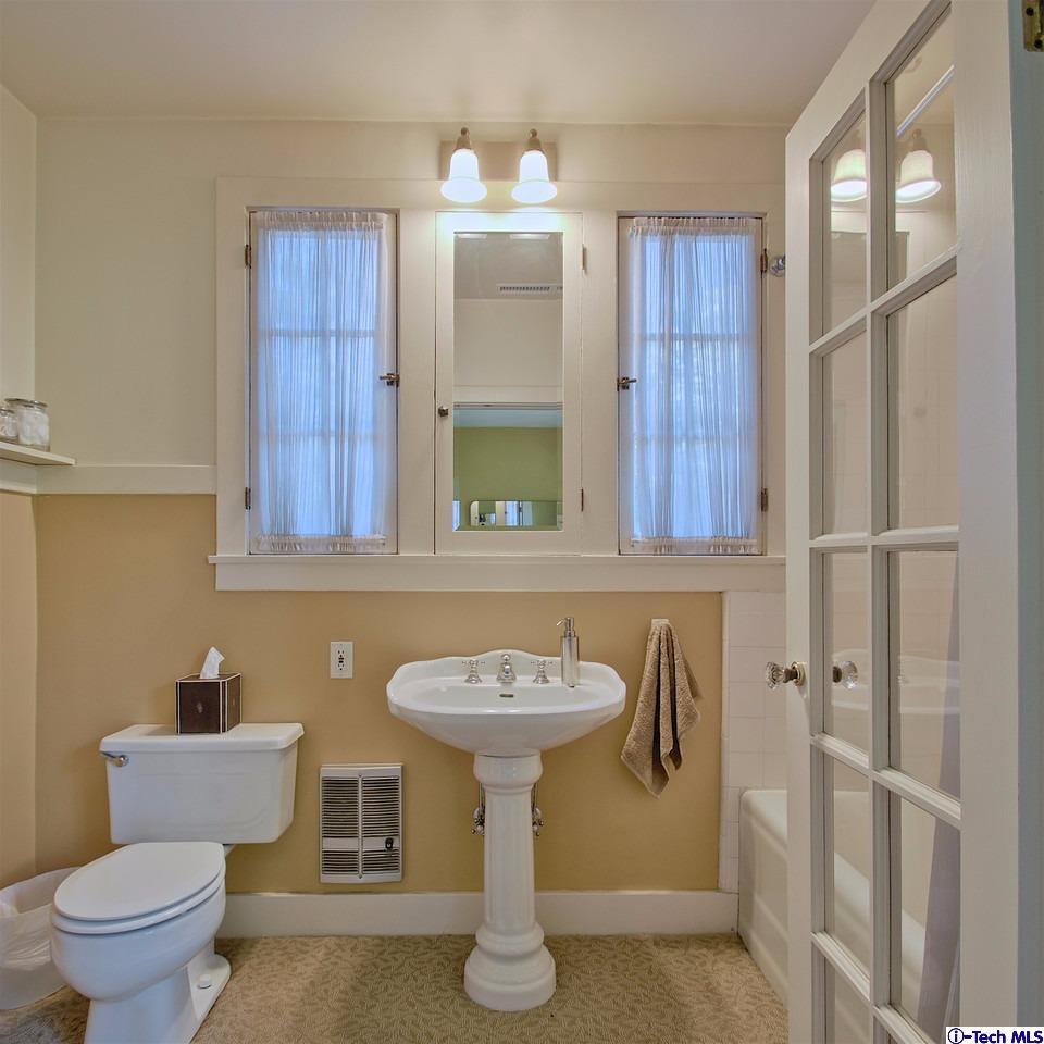 895 South Madison Avenue Pasadena, CA 91106 - Photo 16 of 38 a bathroom with a sink a toilet and mirror