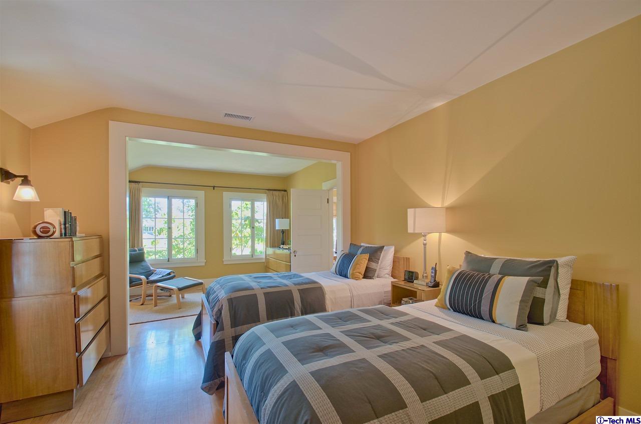 895 South Madison Avenue Pasadena, CA 91106 - Photo 18 of 38 a bedroom with two beds and a large mirror next to a window