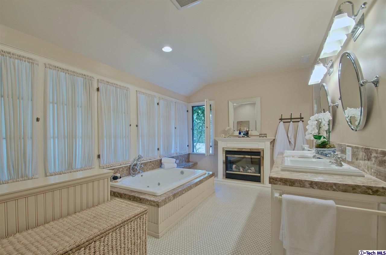 895 South Madison Avenue Pasadena, CA 91106 - Photo 28 of 38 a living room with furniture a fireplace and a chandelier