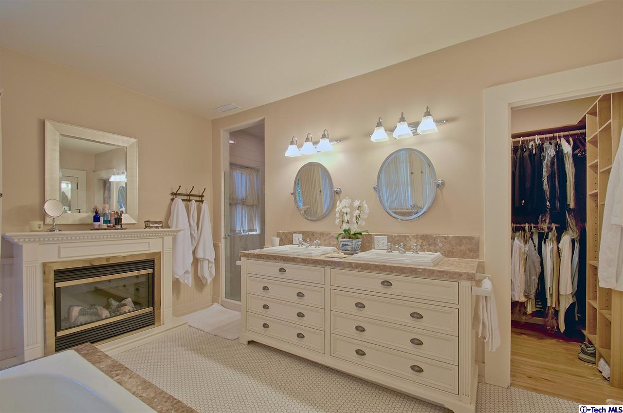 895 South Madison Avenue Pasadena, CA 91106 - Photo 29 of 38 a living room with furniture a mirror and a fireplace