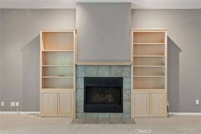 a view of a room with a ceiling fan and window