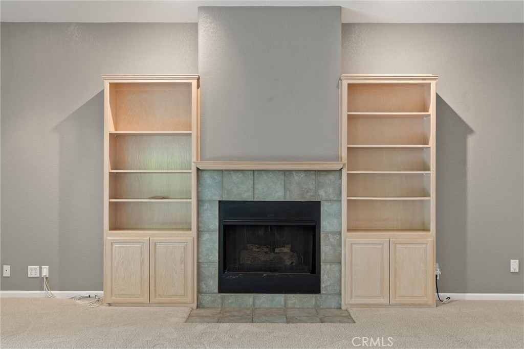 43 Edgewater Court Chico, CA 95928 - Photo 11 of 59 a living room with a fireplace and a ceiling fan