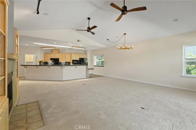 a kitchen with stainless steel appliances granite countertop a refrigerator a sink and a stove