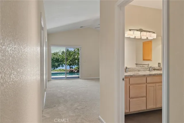 an empty room with closet and a chandelier fan