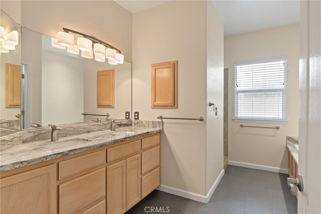 43 Edgewater Court Chico, CA 95928 - Photo 31 of 59 a bathroom with a double vanity sink and mirror with window