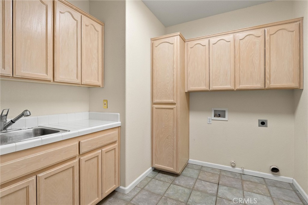43 Edgewater Court Chico, CA 95928 - Photo 40 of 59 a kitchen with white cabinets and a sink