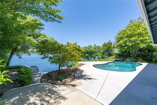 an aerial view of residential houses with outdoor space and swimming pool