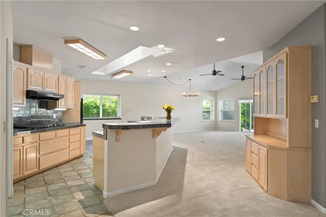 a living room with a fireplace and a ceiling fan