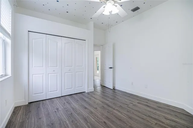 an empty room with wooden floor