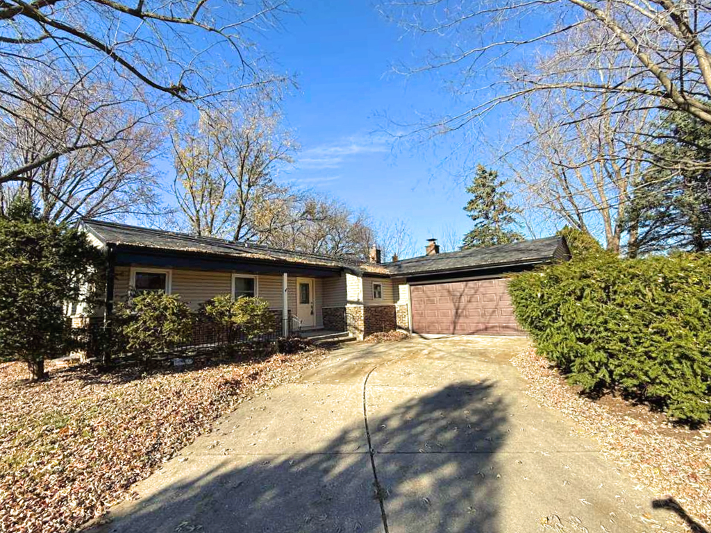 a view of a house with a yard covered in snow