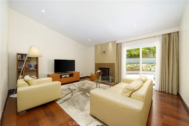 a dining room with furniture a chandelier and window