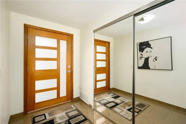 a bedroom with a bed and a large window