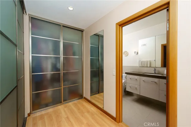 a bathroom with a double vanity sink toilet mirror and shower