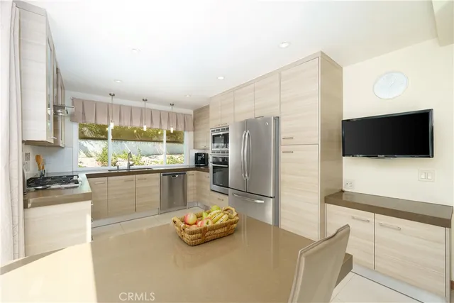 a kitchen with a table chairs refrigerator and cabinets